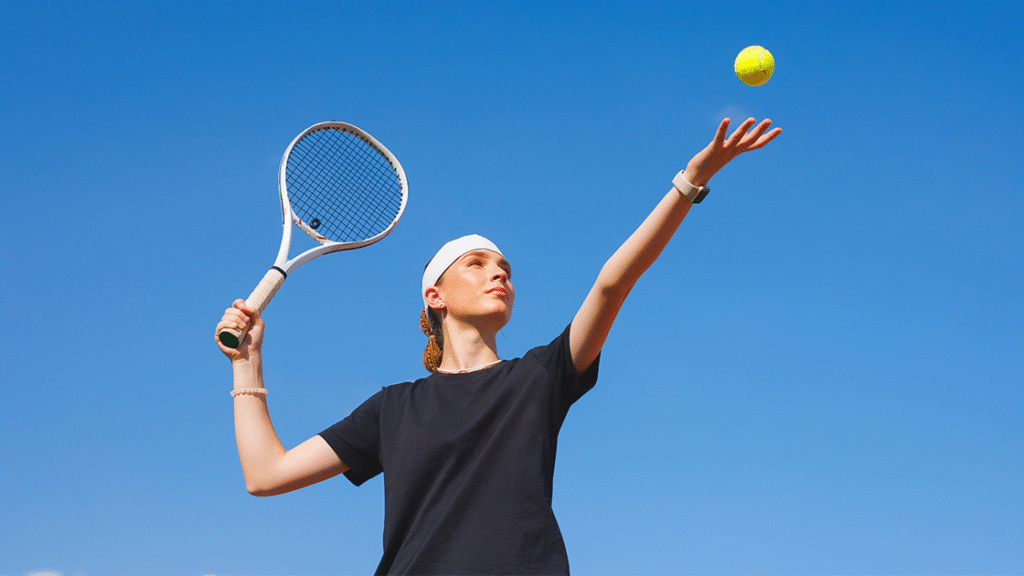 Male tennis player hitting a forehand shot, illustrating tennis elbow risk from repetitive arm movements